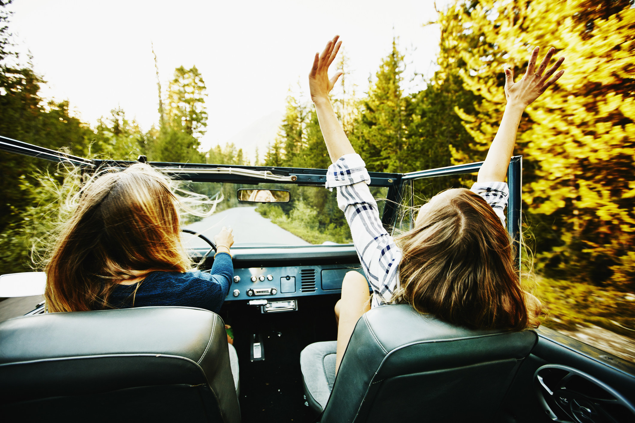 Woman riding with friend in convertible