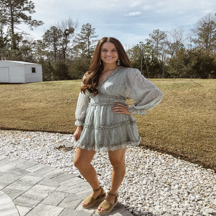 reviewer wearing dress in blue