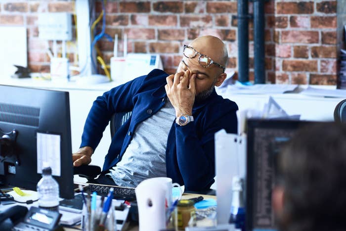 Tired man sitting at a desk in his office