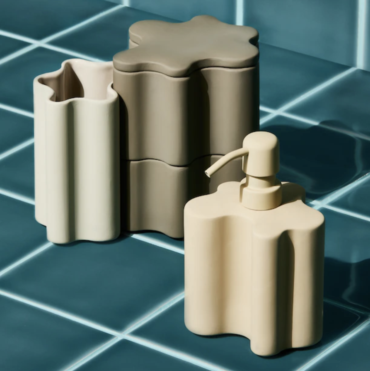 a set of three canisters and a soap bottle with irregular shapes