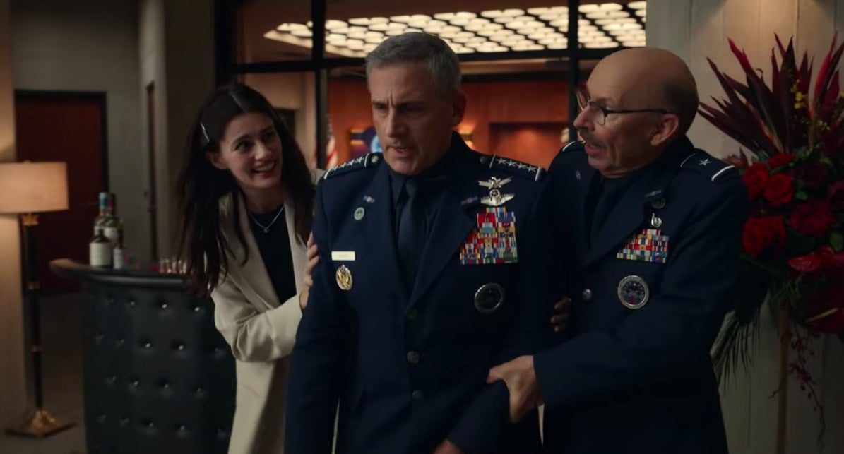 Erin and Brad guiding a drunken Mark in "Space Force"