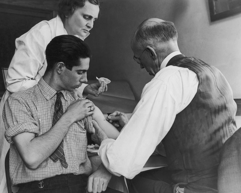 a man receiving his smallpox vaccine decades ago
