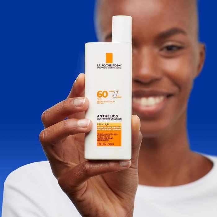 A model holding the sunscreen