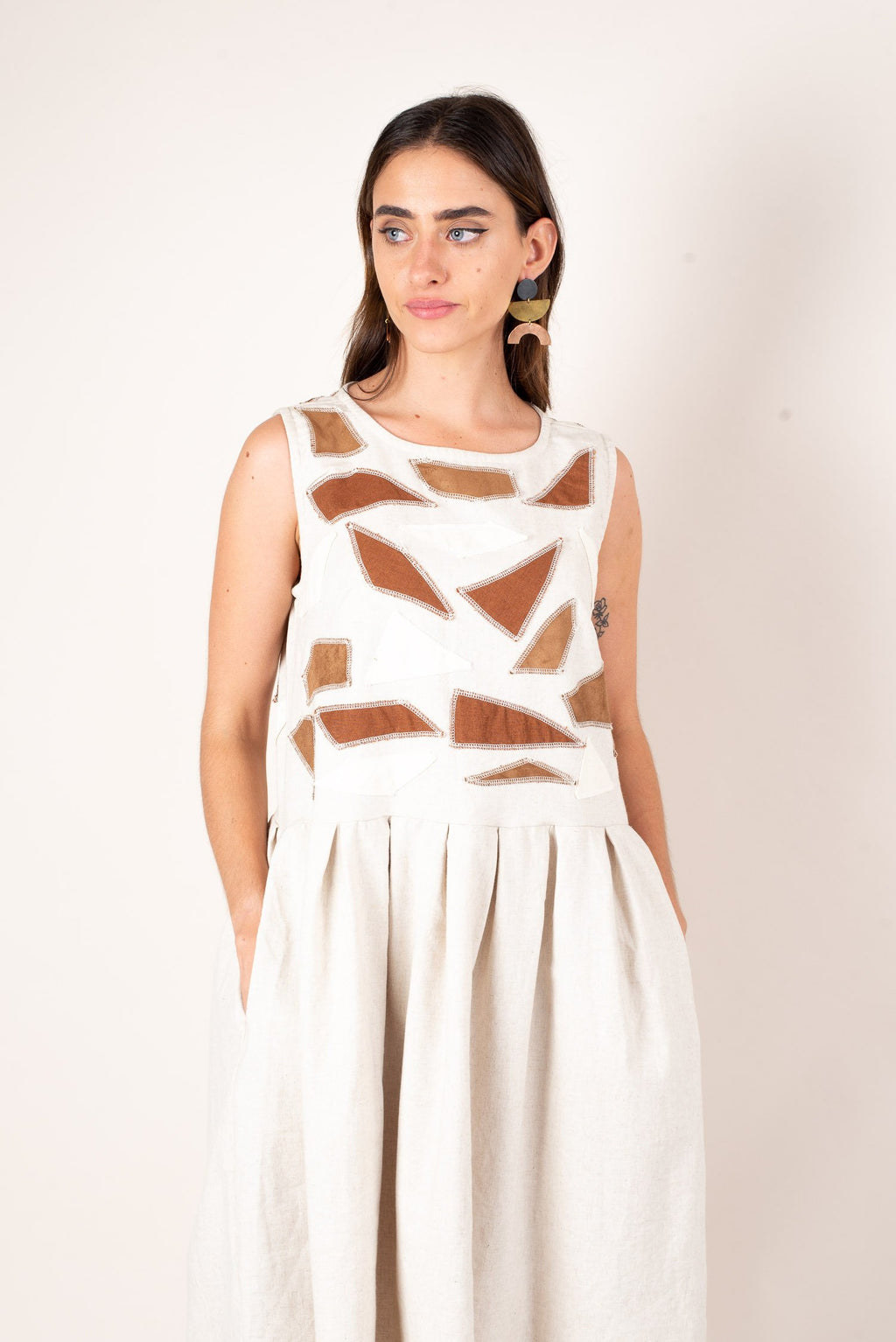 model wearing white and brown-detailed dress