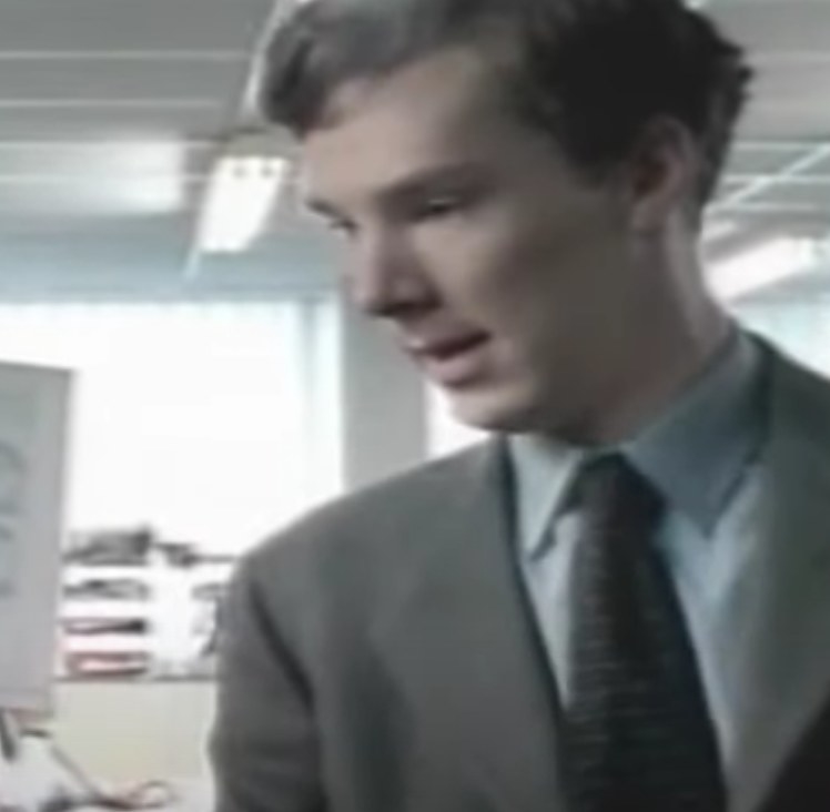 Benedict Cumberbatch as Jeremy talks to a coworker