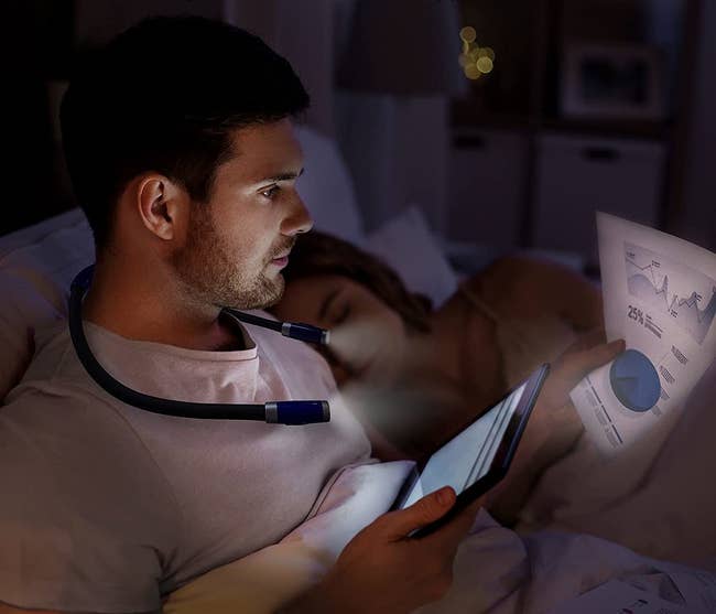 Model wearing reading light in bed