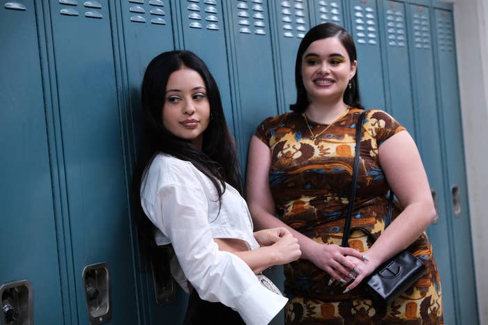 Two girls standing against their school's lockers