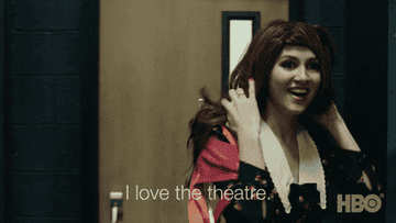 Lexi in a wig and talking about her love of the theatre
