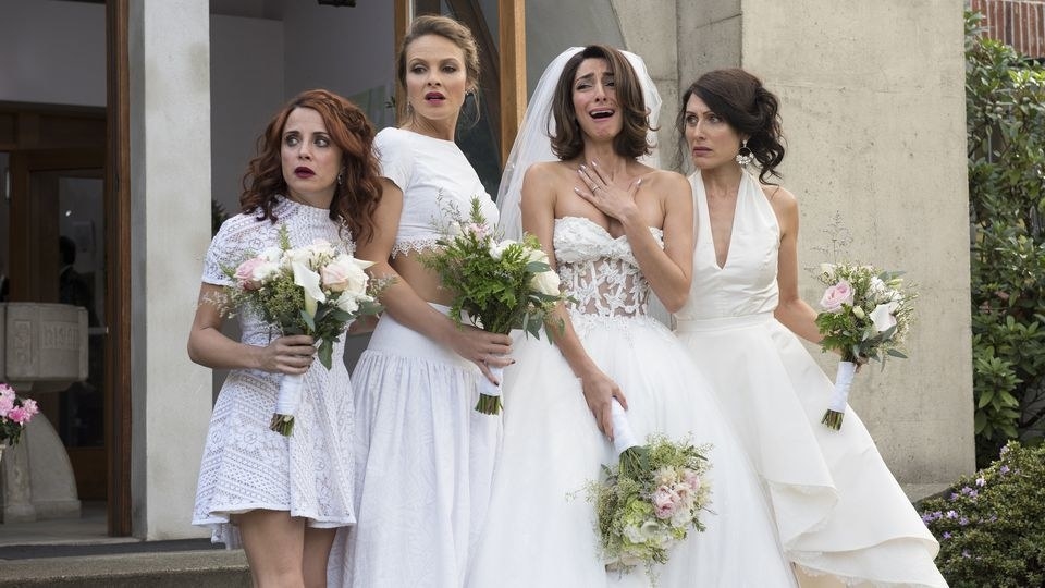 Four women distraught wearing wedding dressing and holding bouquets