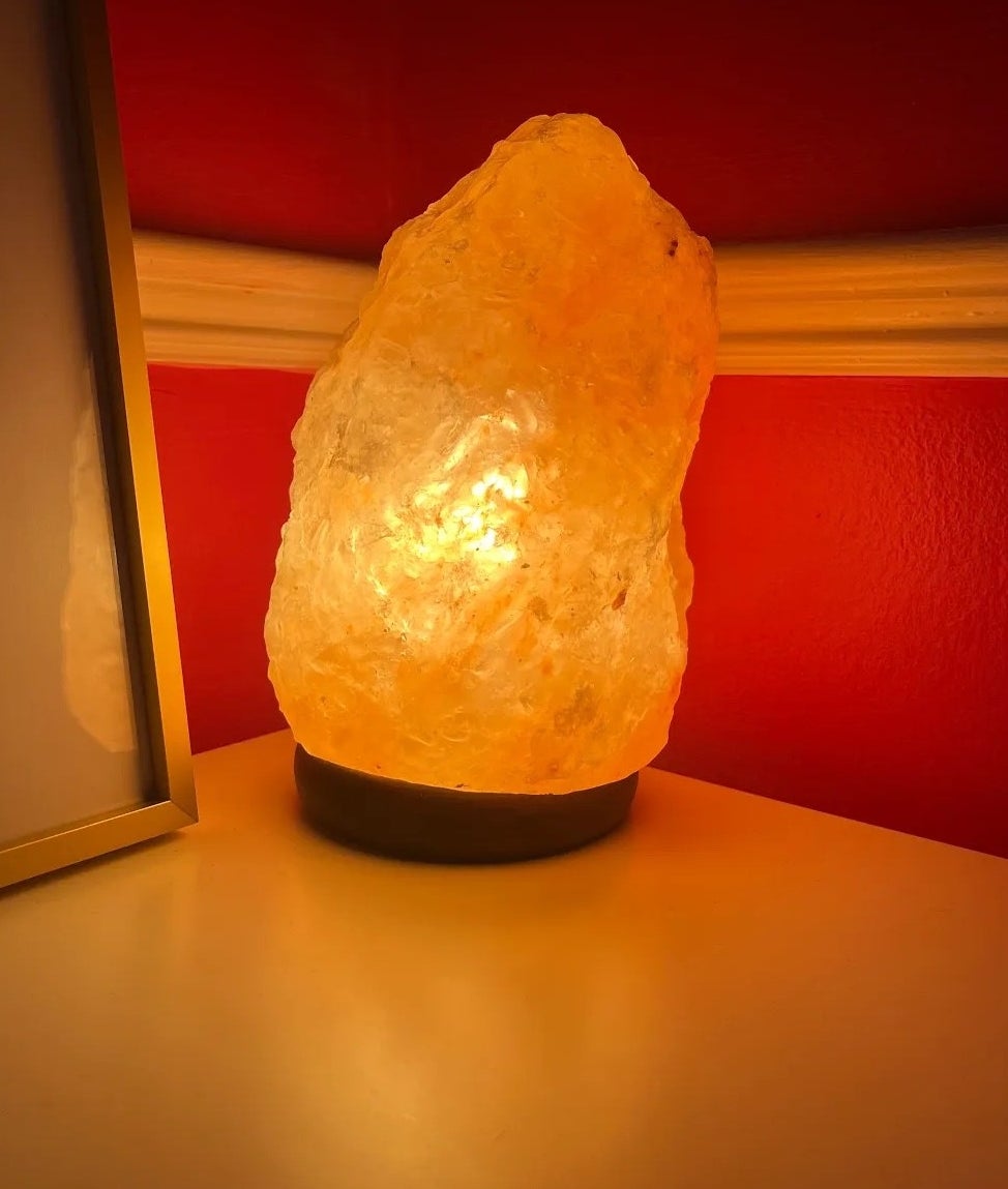 A salt lamp on in the corner of Bianca&#x27;s room giving off a soft amber glow