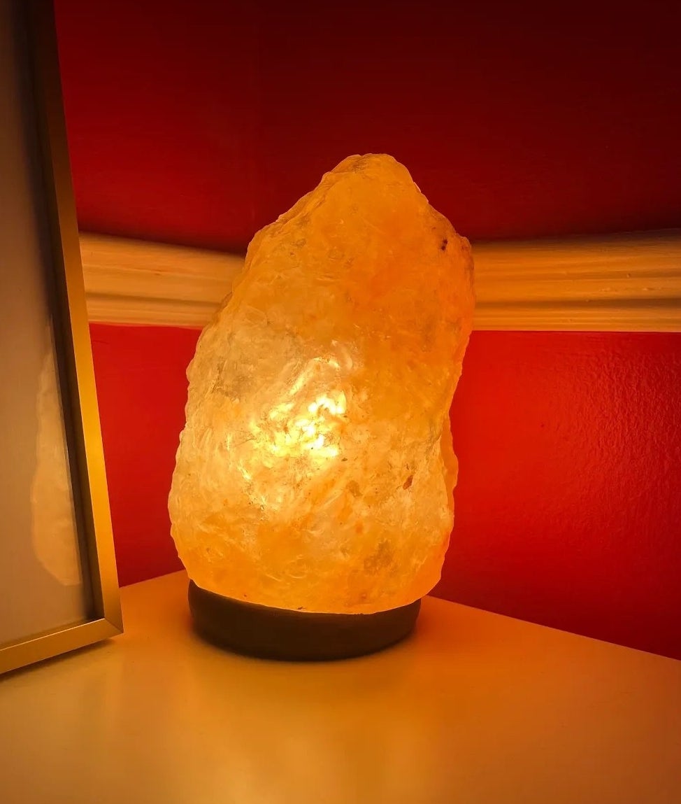 A salt lamp on in the corner of Bianca&#x27;s room giving off a soft amber glow