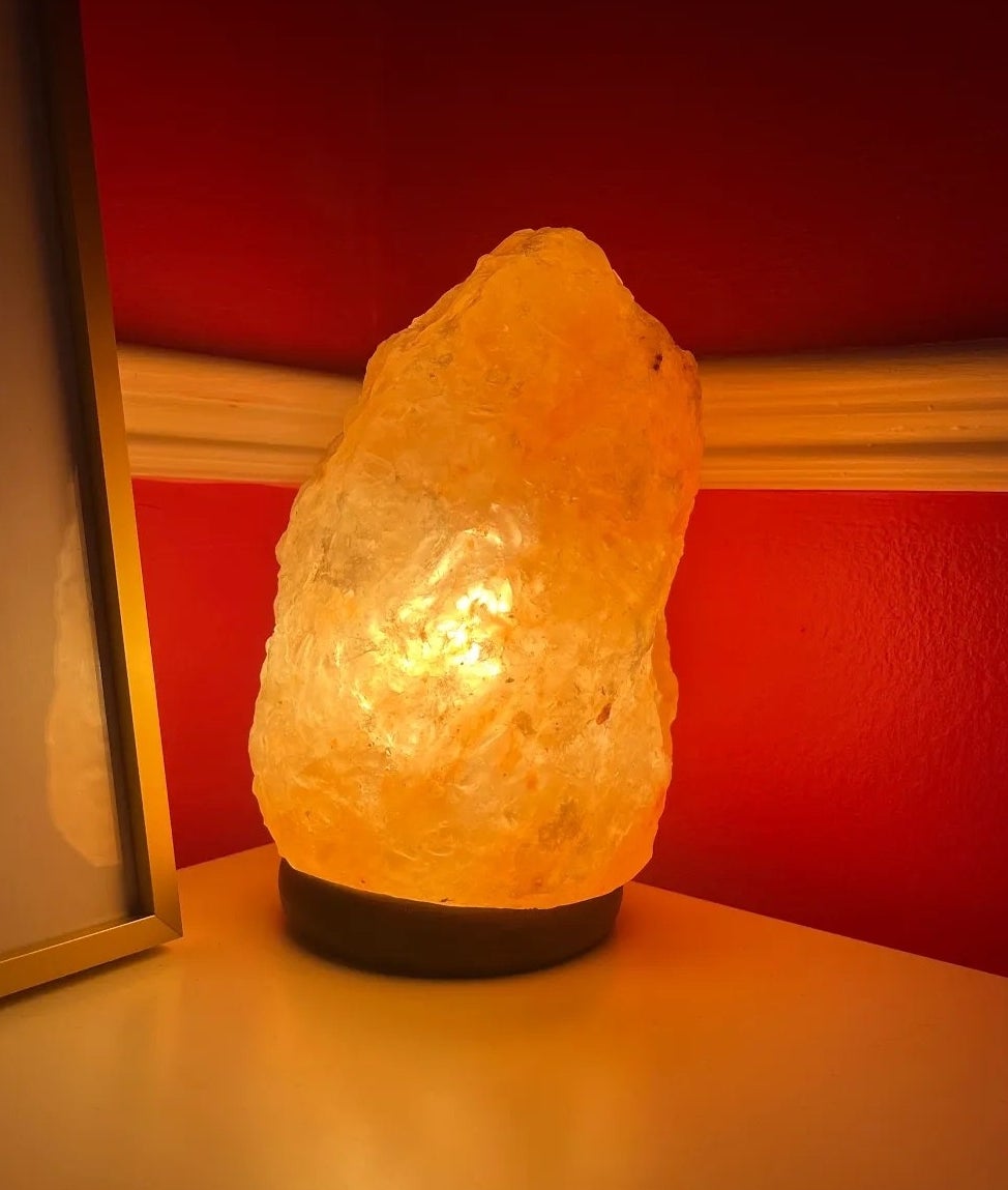 A salt lamp on in the corner of Bianca's room giving off a soft amber glow