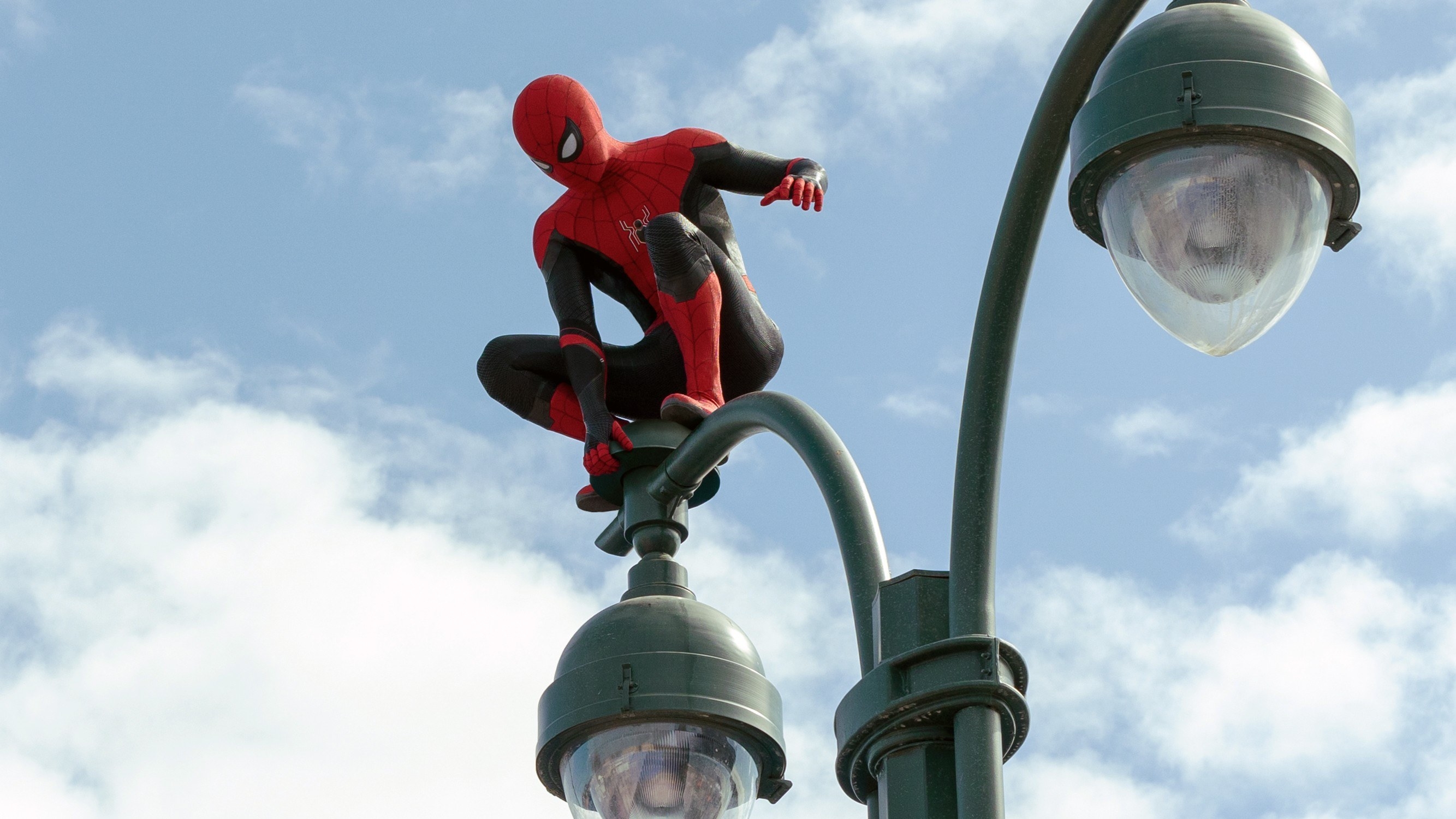 Spider-Man perches on a lightpost