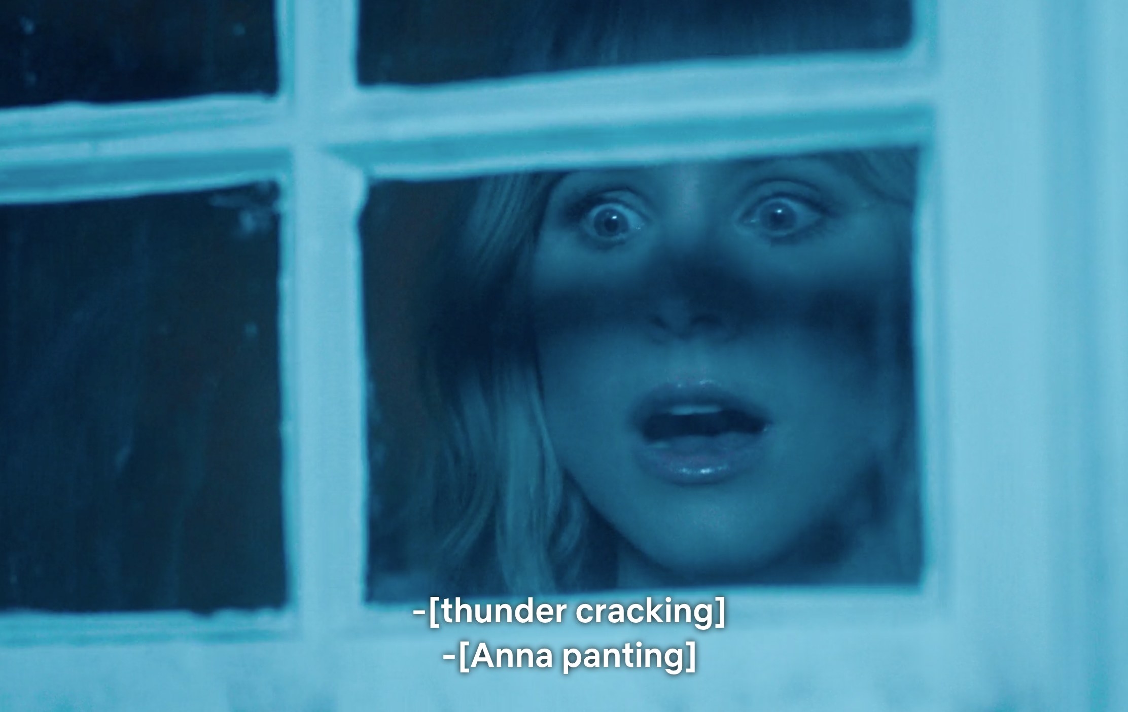Bell as Anna looking through her window with a terrified expression on her face as thunder cracks and she pants
