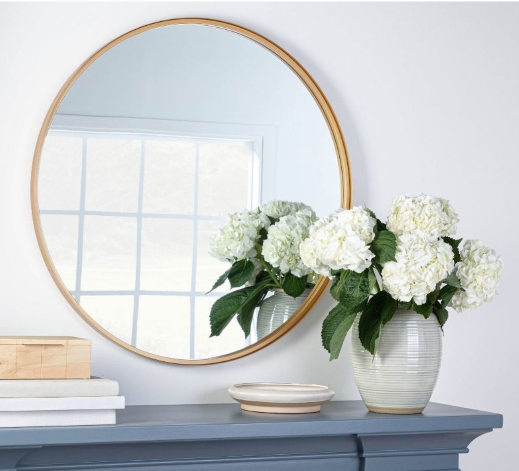 A round gold decorative wall mirror