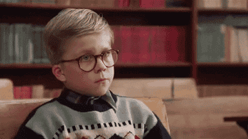 gif of ralphie from a christmas story putting his head down on his desk at school