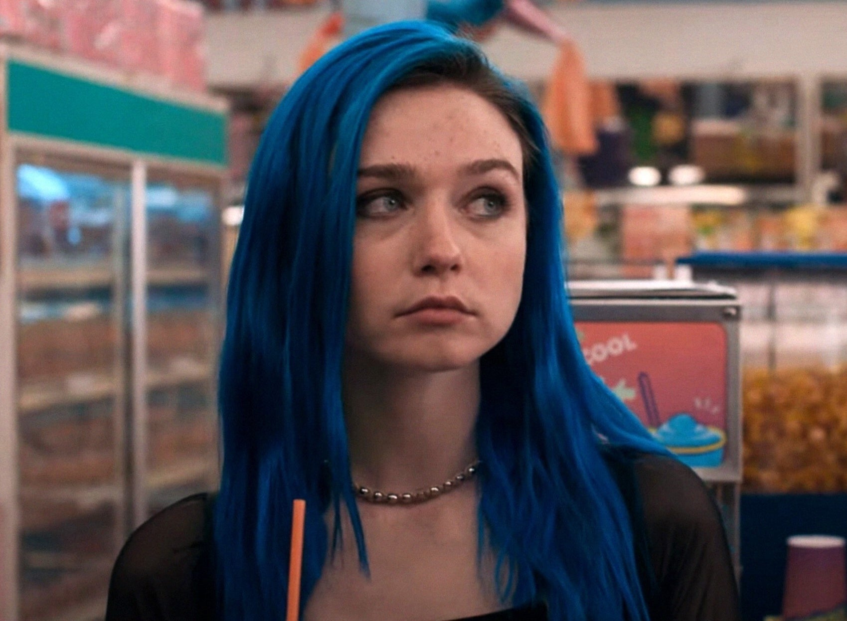 jessica barden as winona in pink skies ahead with long dark blue hair with dark roots and a side part