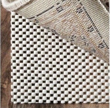 The non-slip pad underneath the corner of a rug