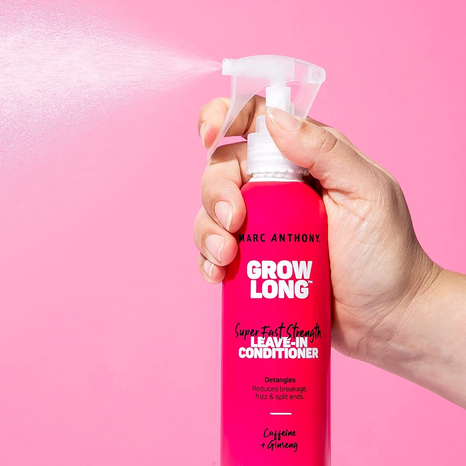 a person spritzing the leave-in conditioner into the air