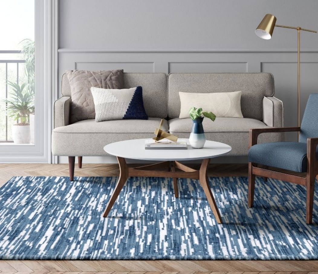 A blue/white lined tufted area rug