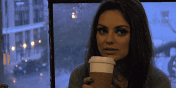 Mila Kunis drinking coffee