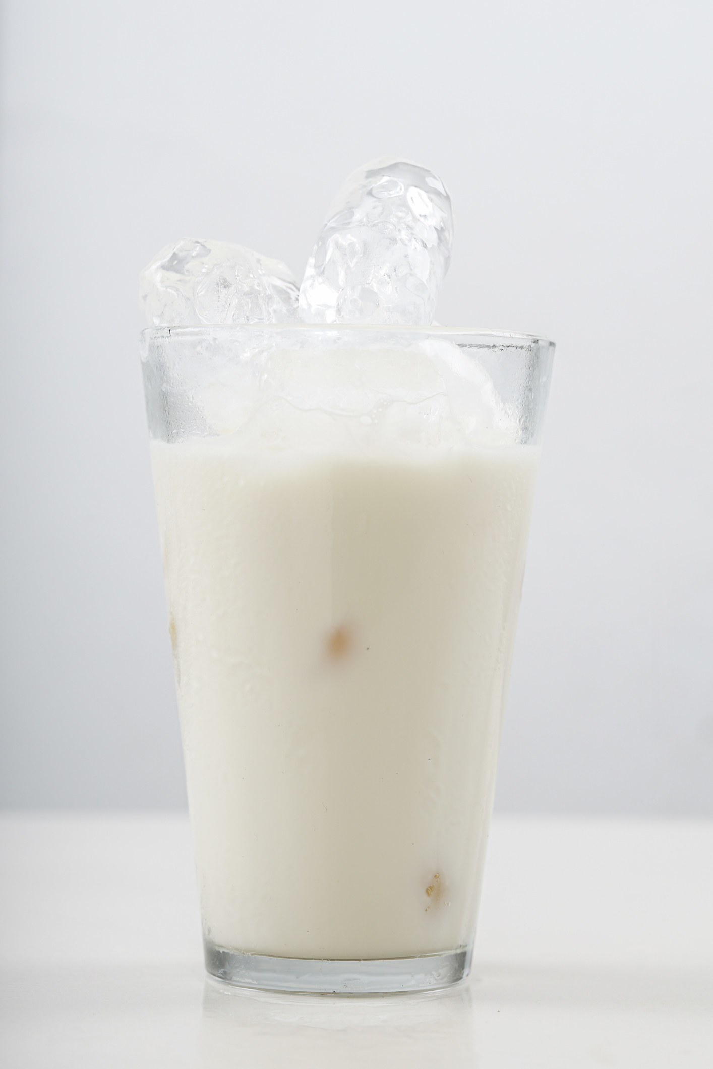 A glass of milk with ice.