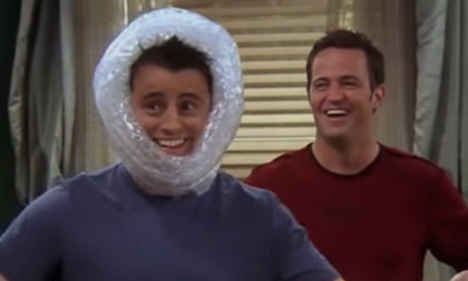 Joey with bubble wrap on his head and Chandler behind him in &quot;Friends&quot;