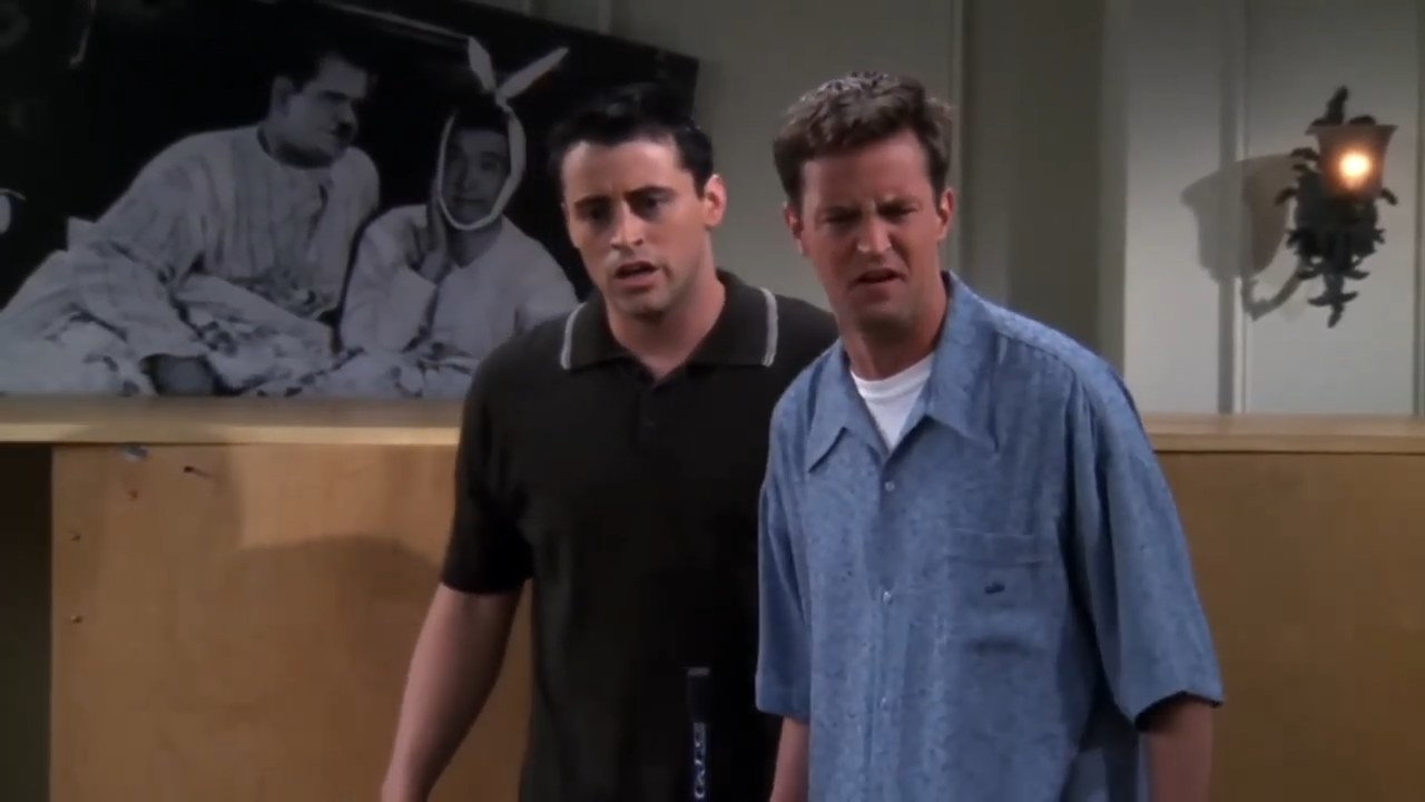 Joey and Chandler standing surprised in their robbed apartment in &quot;Friends&quot;