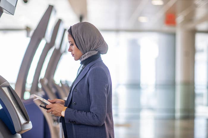 Muslim woman at a kiosk at the airport