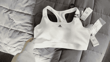 GIF of three different sports bras on bed