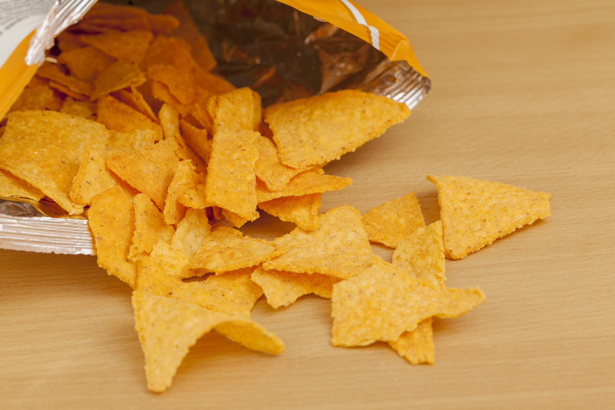 Doritos chips on a wooden table.
