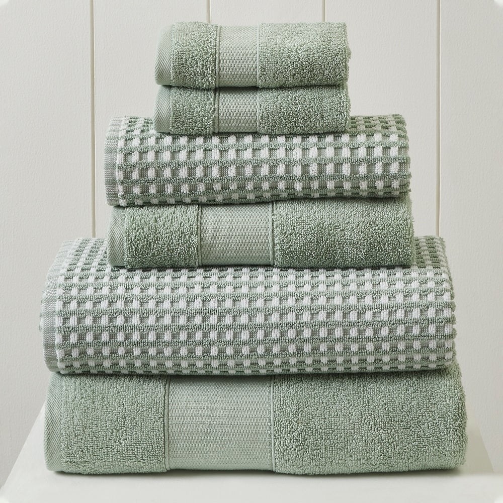 a set of six green towels with varying weaves