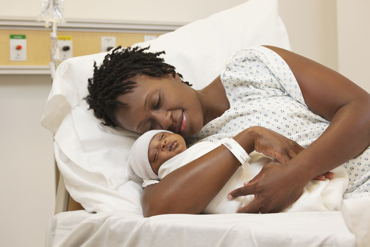 Mother holding newborn in the hospital