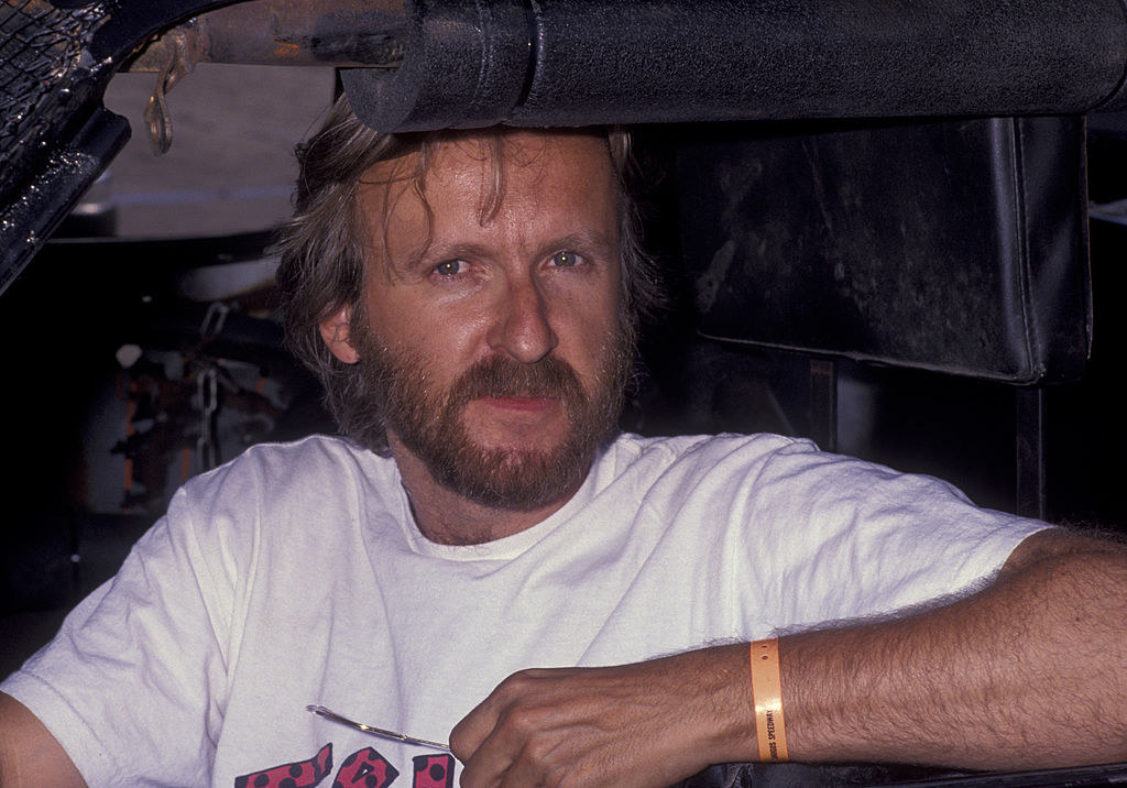Close up of James Cameron in a race car in 1992