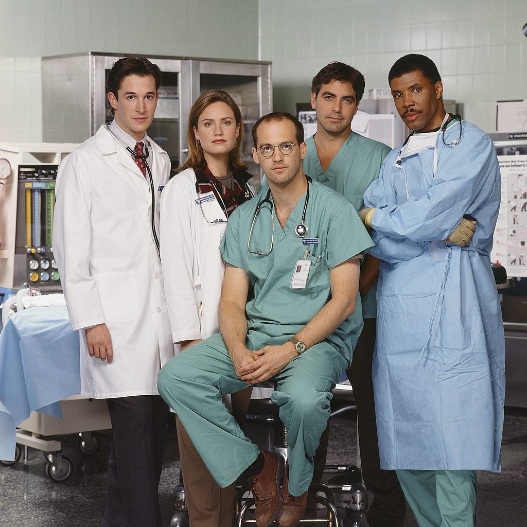 Promo photo of ER cast sitting in operating room