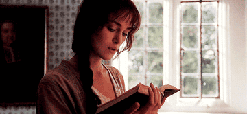 Elizabeth Bennett wistfully reading her book in her bedroom