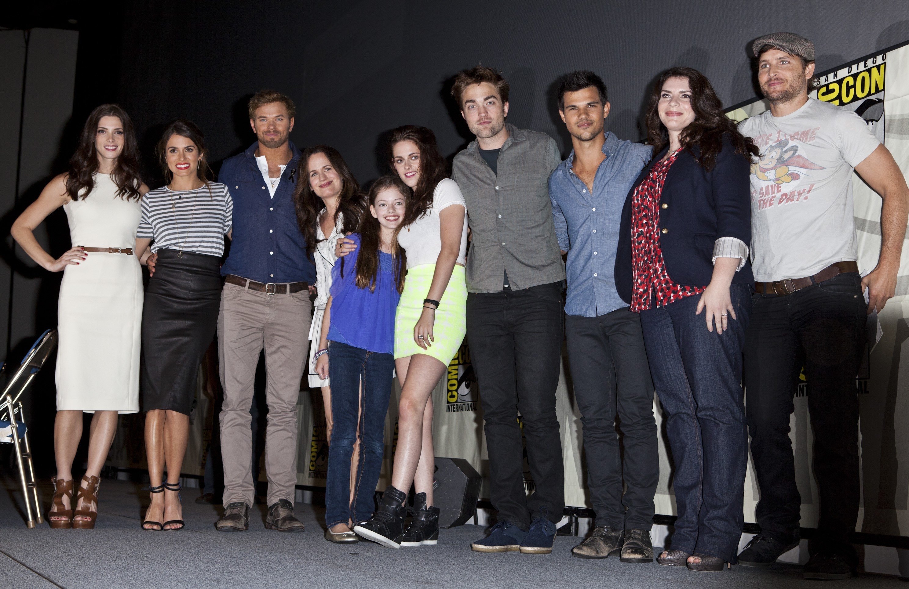 The cast poses together on stage