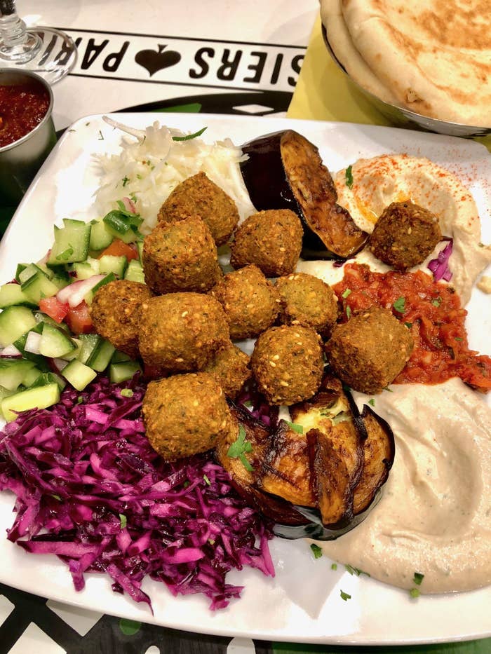 A falafel platter with hummus and eggplant