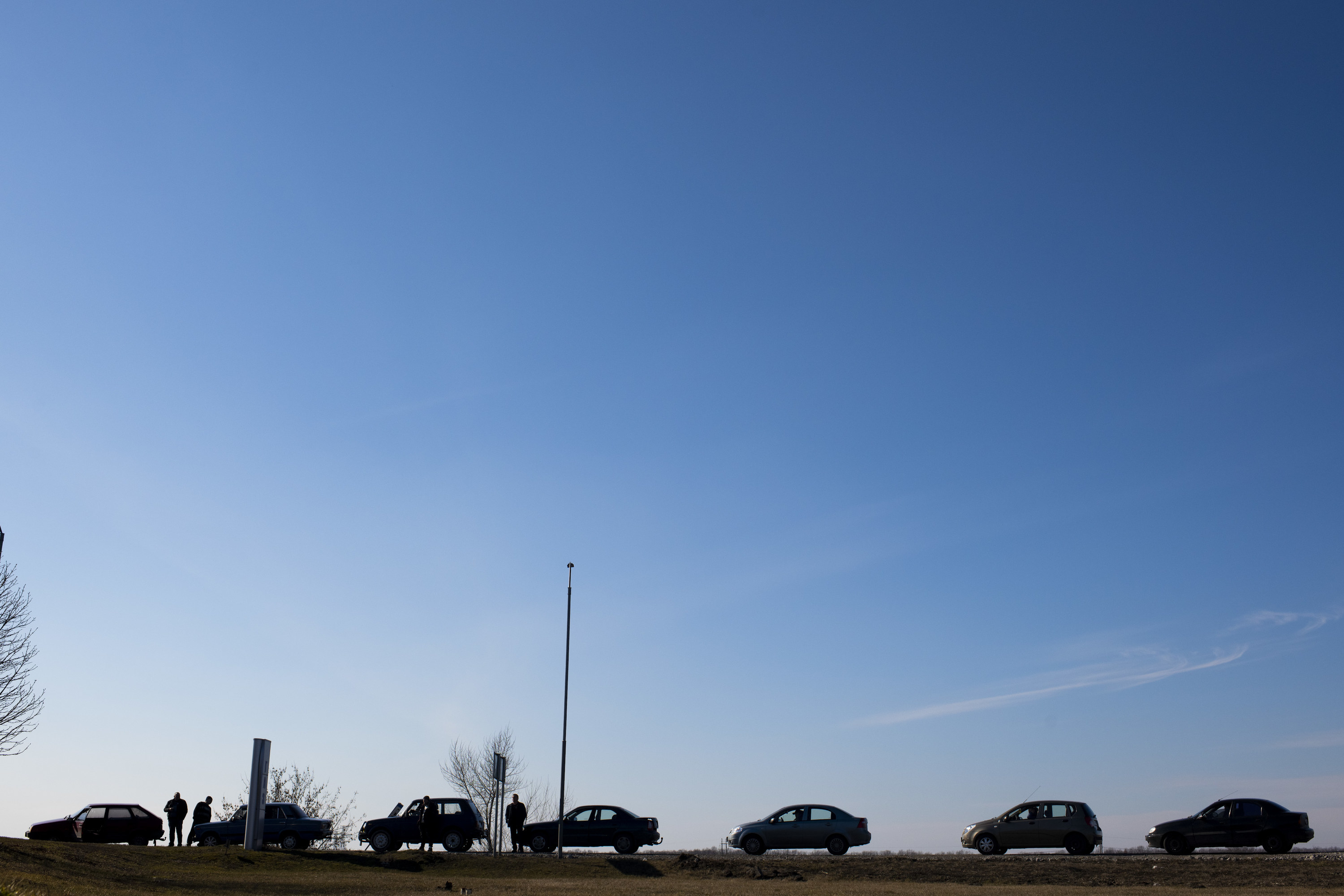 Seven cars wait in a line