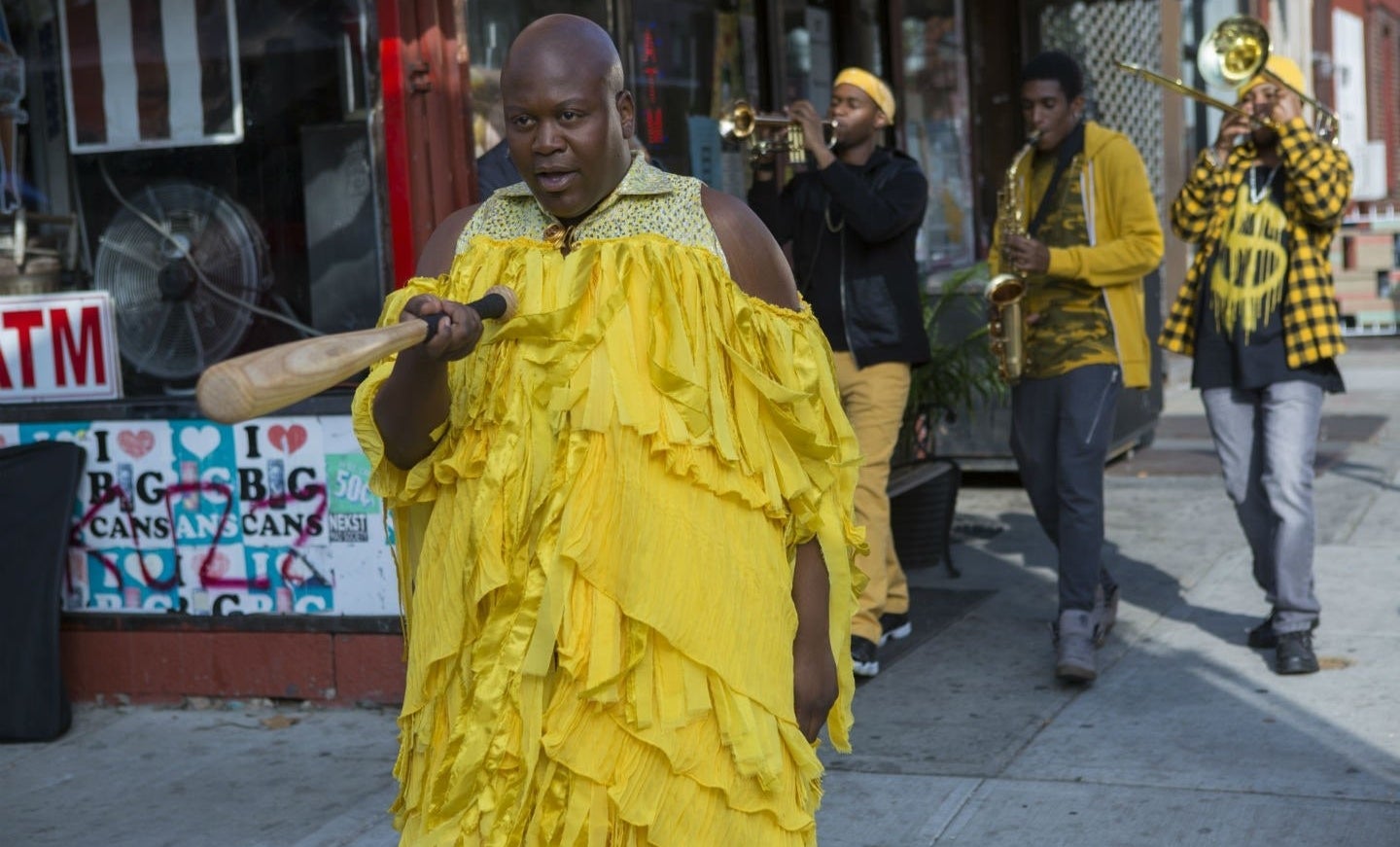 Tituss Burgess as "Titus" is doing a Beyoncé-inspired parody video ("Lemonade"), and he's seen holding a bat wearing a frilly dress in Unbreakable Kimmy Schmidt