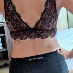a third reviewer showing the back of the dark red bralette