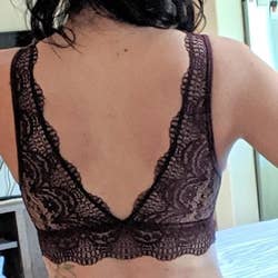 a third reviewer showing the back of the dark red bralette