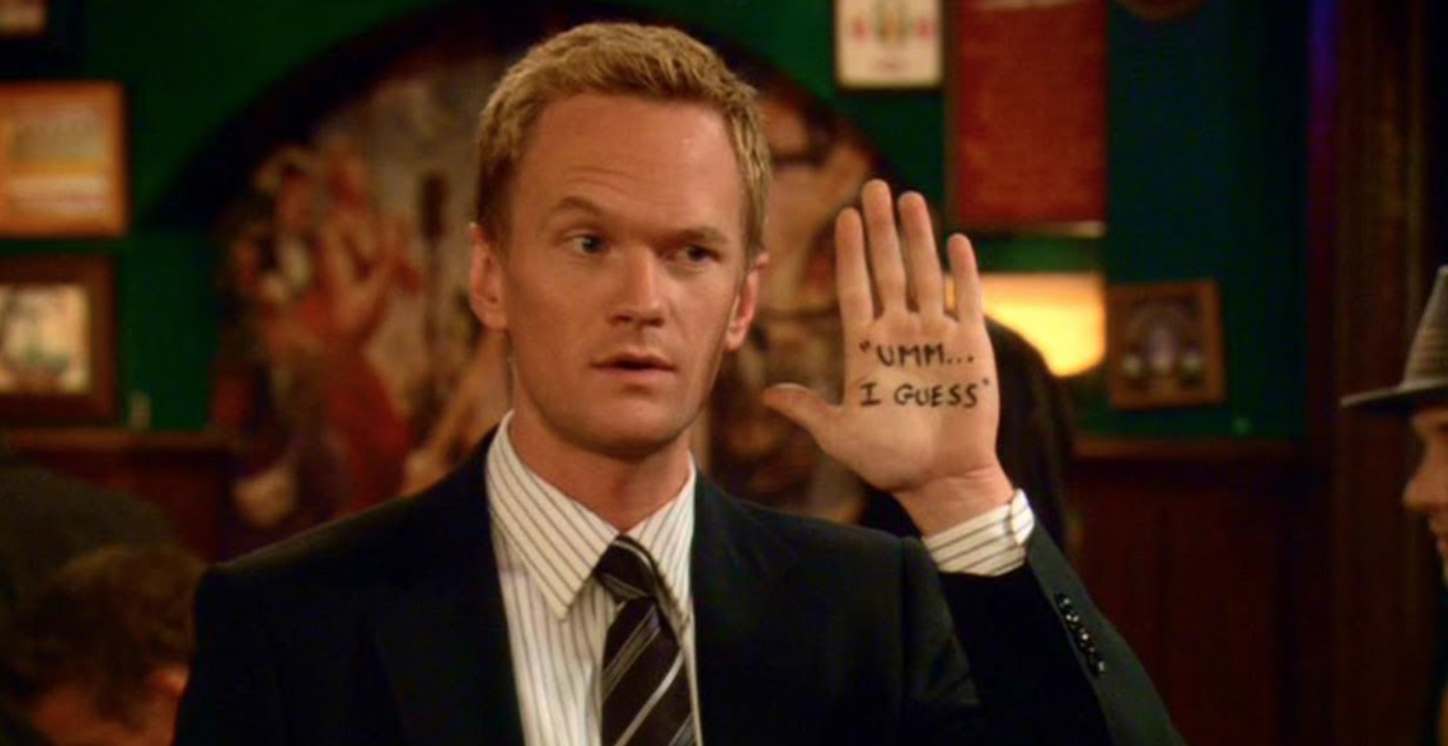 Barney from &quot;How I Met Your Mother&quot; holds up a hand, which has &quot;Um, I guess&quot; handwritten on his palm