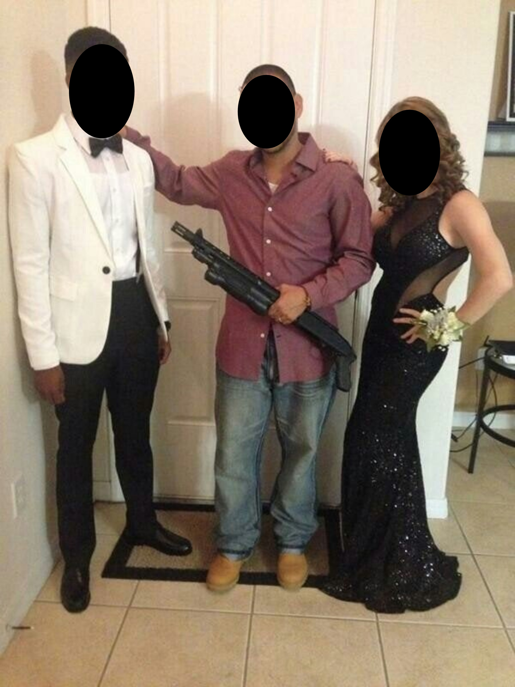 Another dad posing with his daughter and her date, but this dad is holding a large shotgun that is actually pointed right at the date