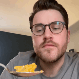GIF of the author eating the Walmart mac &#x27;n&#x27; cheese ending with a &quot;chef&#x27;s kiss&quot; gesture