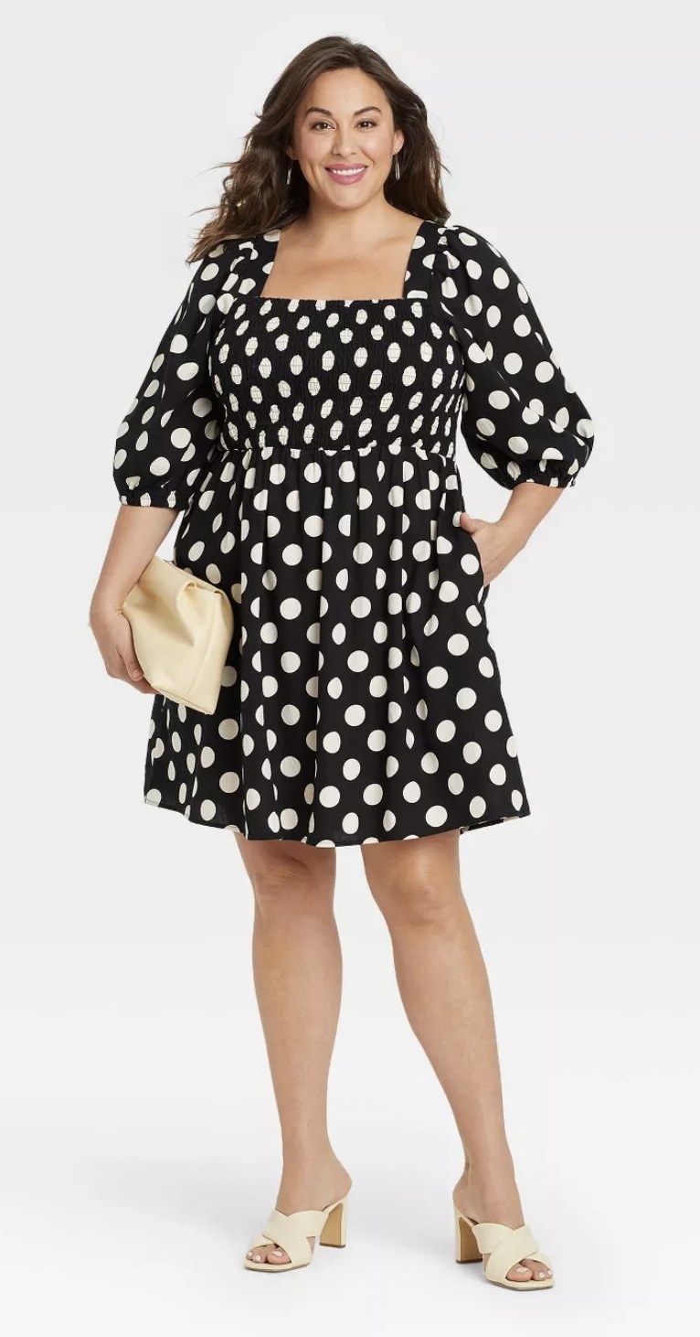 front view of model wearing the dress in black with white polka dots