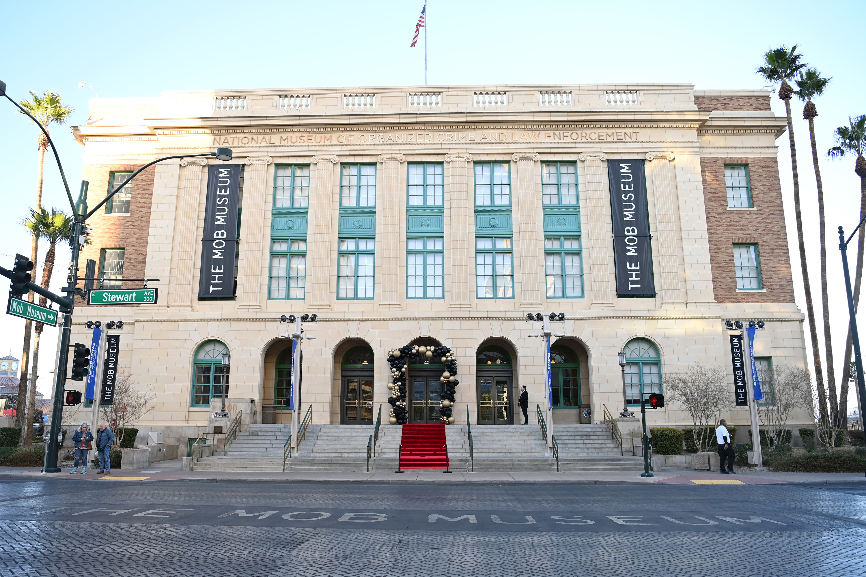 The Mob Museum in Las Vegas, a light-colored historical building surrounded by palm trees, on a sunny day