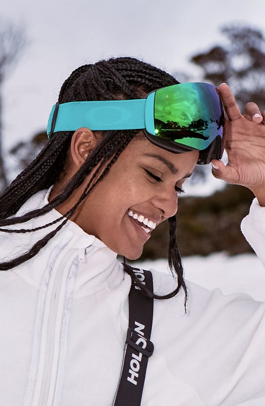 Model wearing the blue ski goggles outside