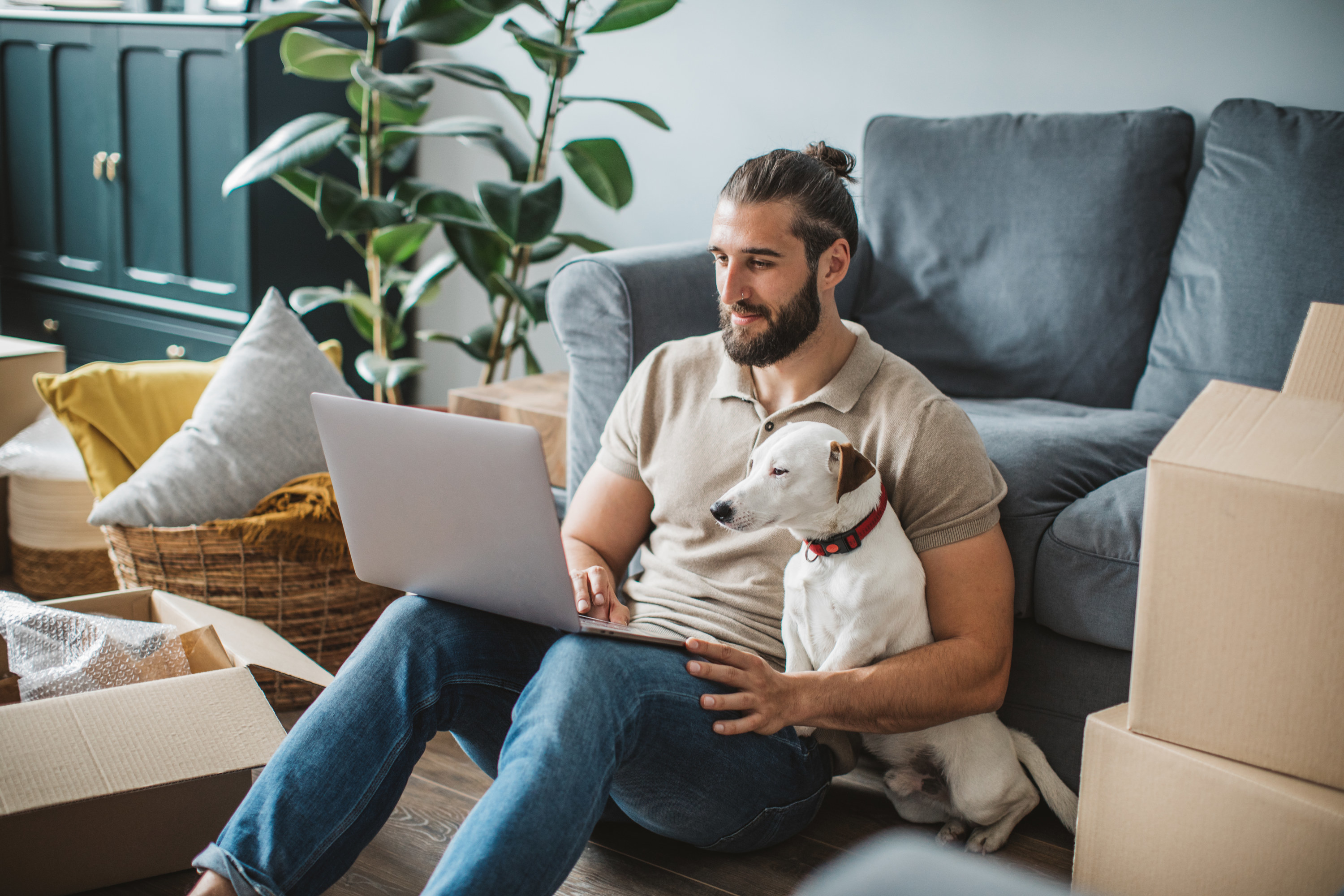 Young man and his dog moving into a new house