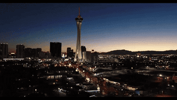 The Las Vegas skyline with the STRAT hotel and casino in the middle in front of a fading sunset